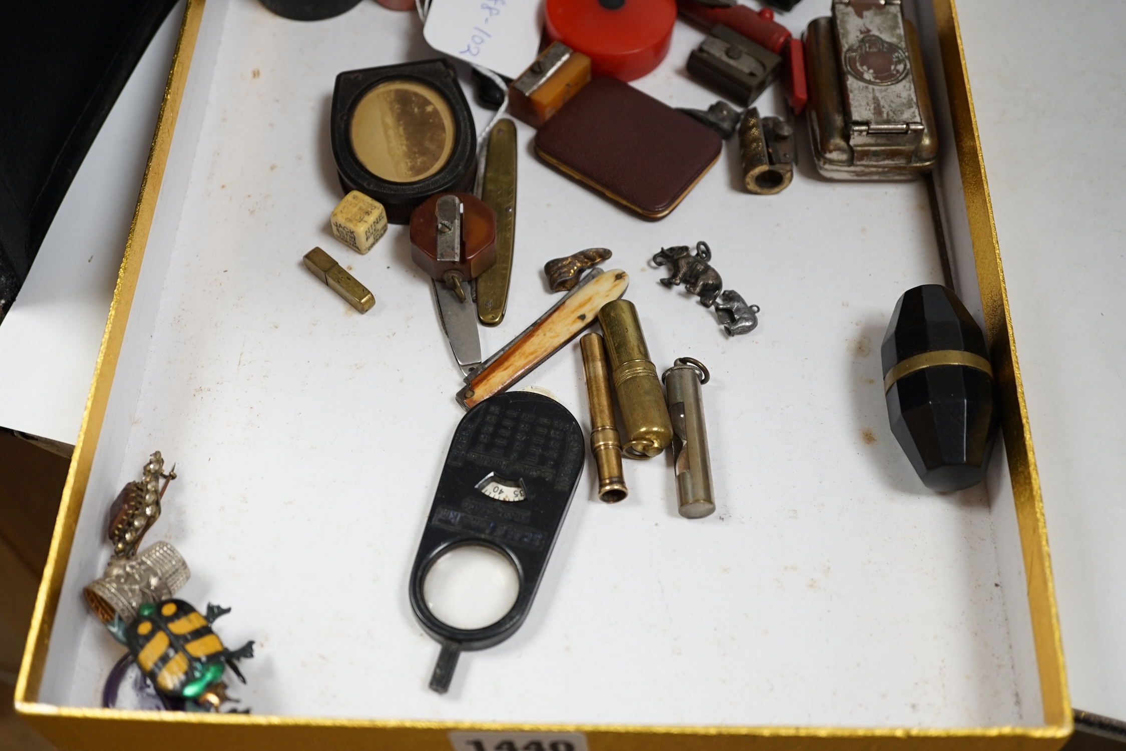 A group of mixed collectables and objects to include Bakelite boxes, pen knives, white metal charms and a gilt metal compact, etc. Condition - varies, fair